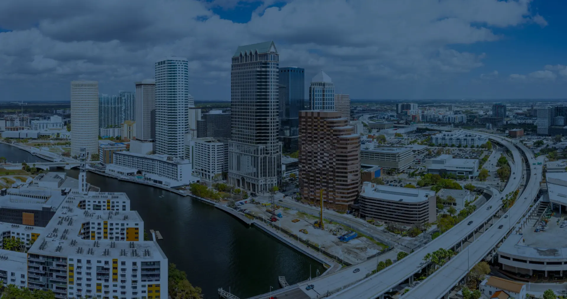 Panoramic aerial photograph of the downtown Tampa city skyline and waterways, representing the local service area covered by a professional Roofing Company in Tampa.