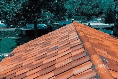 Clay tile roof in good condition, demonstrating a durable solution to protect and preserve roofing in residential homes.