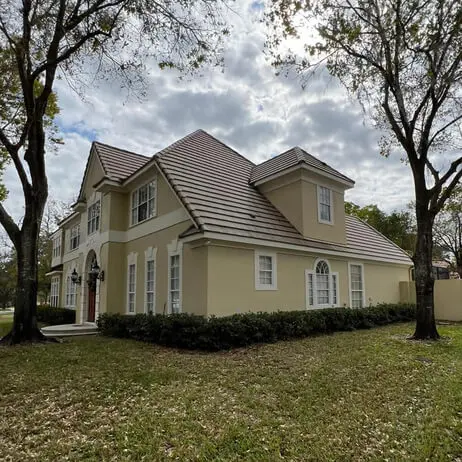 A beautiful large residential home featuring a classic clay tile roof, demonstrating the quality of protect preserve roofing solutions.