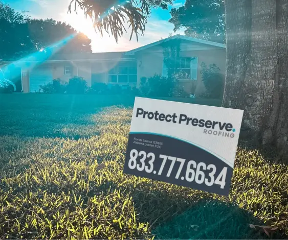 A Protect Preserve Roofing yard sign displayed in front of a home, signaling the successful completion of professional new roof services.