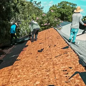 Protect Preserve Roofing crew removing old roofing materials to expose the wooden deck, preparing the residential roof for a new installation.