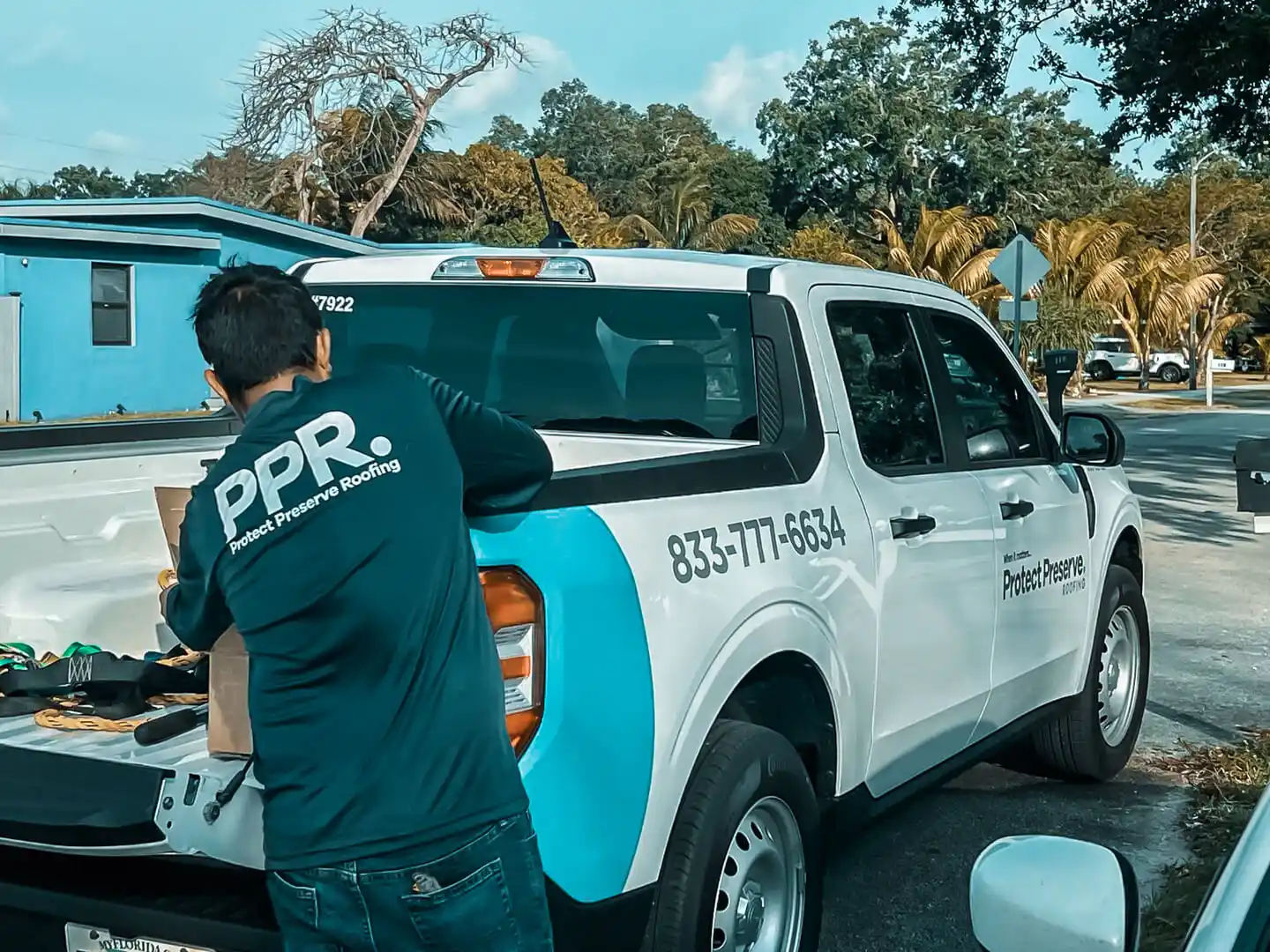 Protect Preserve Roofing team member working at the company truck, providing professional roofing services