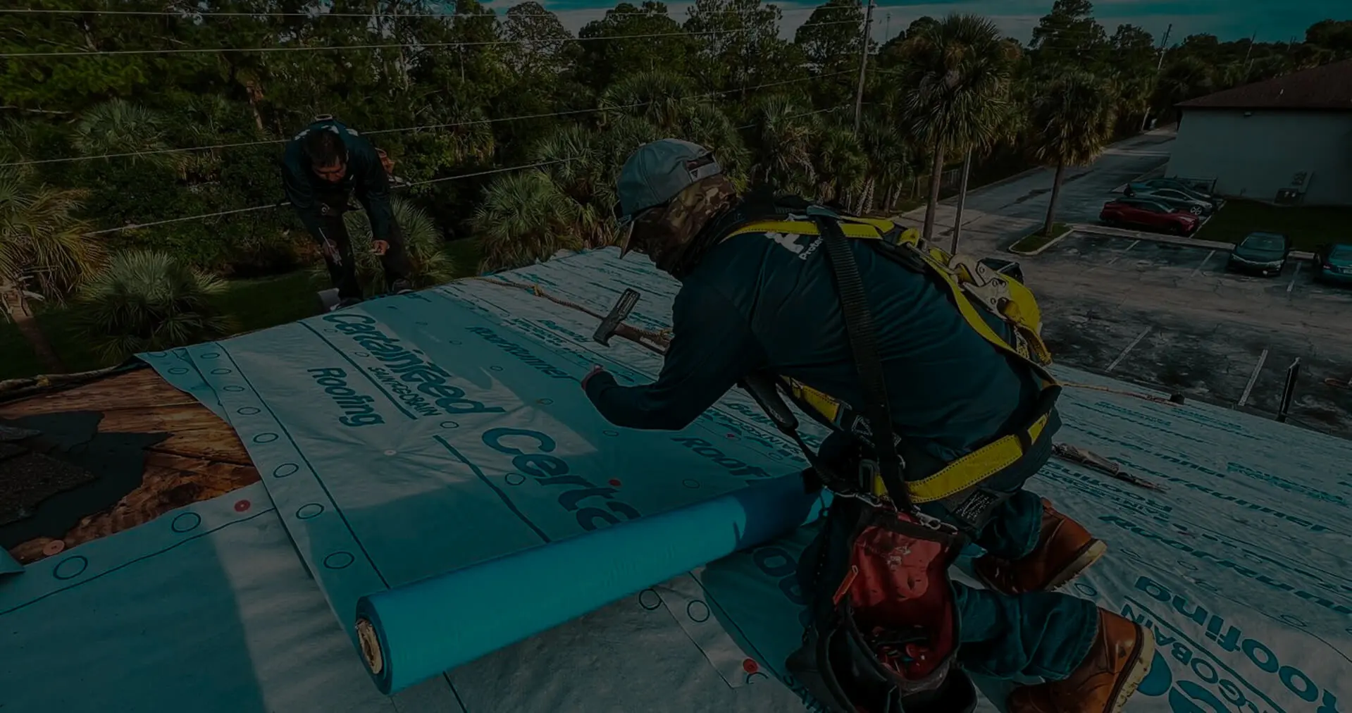 Professional roofer from Protect Preserve Roofing installing CertainTeed RoofRunner underlayment on a residential roof.