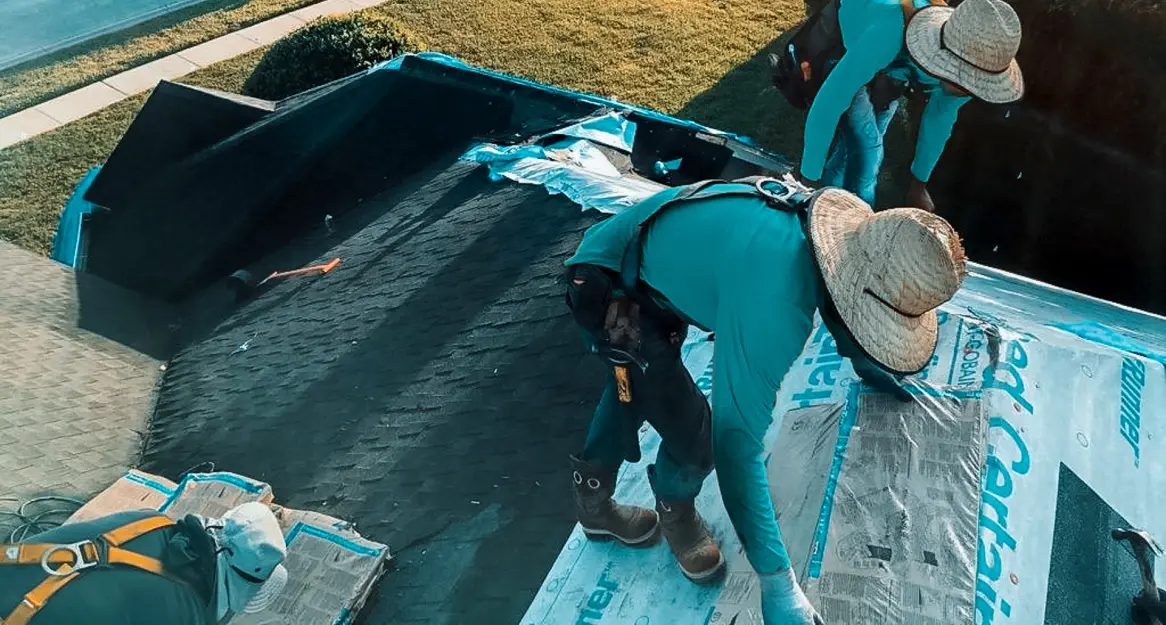 A crew of roofers from Protect Preserve Roofing installing new shingles over CertainTeed underlayment on a residential home's roof.