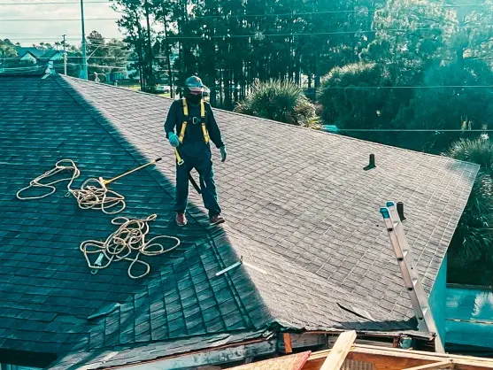 Roof inspection in progress with a licensed roofer working safely on a residential roof, performed by a Roofing Company in St Petersburg.