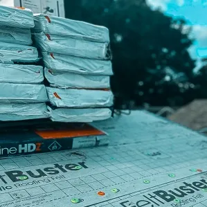 Stacks of new roofing materials and shingles ready for installation, made possible by roof replacement financing made simple.