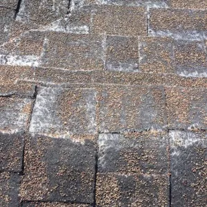 Close-up of worn-out asphalt shingles needing replacement, showing how roof replacement financing made simple can help fix old roofs.