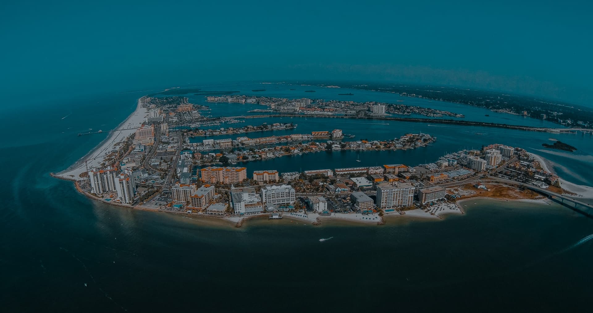 Wide aerial view of Clearwater, Florida, showing coastal buildings and residential areas served by local roofing companies.