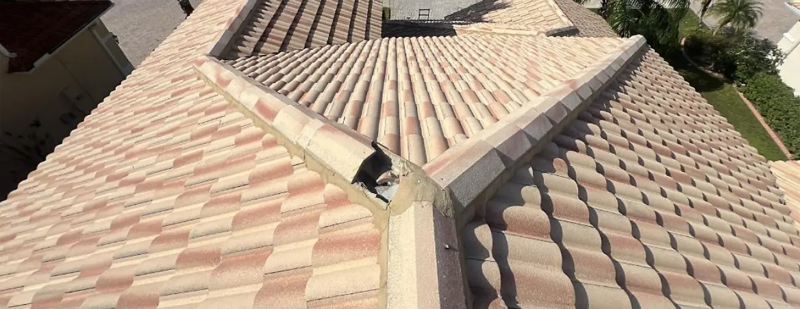 Damaged ridge tile on a residential roof requiring a tile roof repair service.