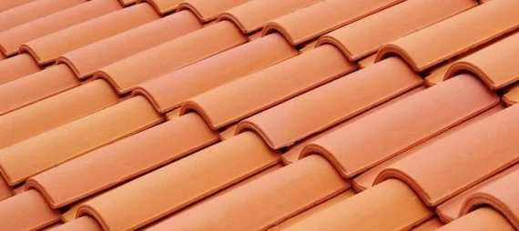 Shaded residential clay tile roof illustrating the durability maintained by a tile roof repair service.