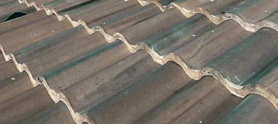 Close-up of grey concrete interlocking roof tiles, a common material managed by a tile roof repair service.