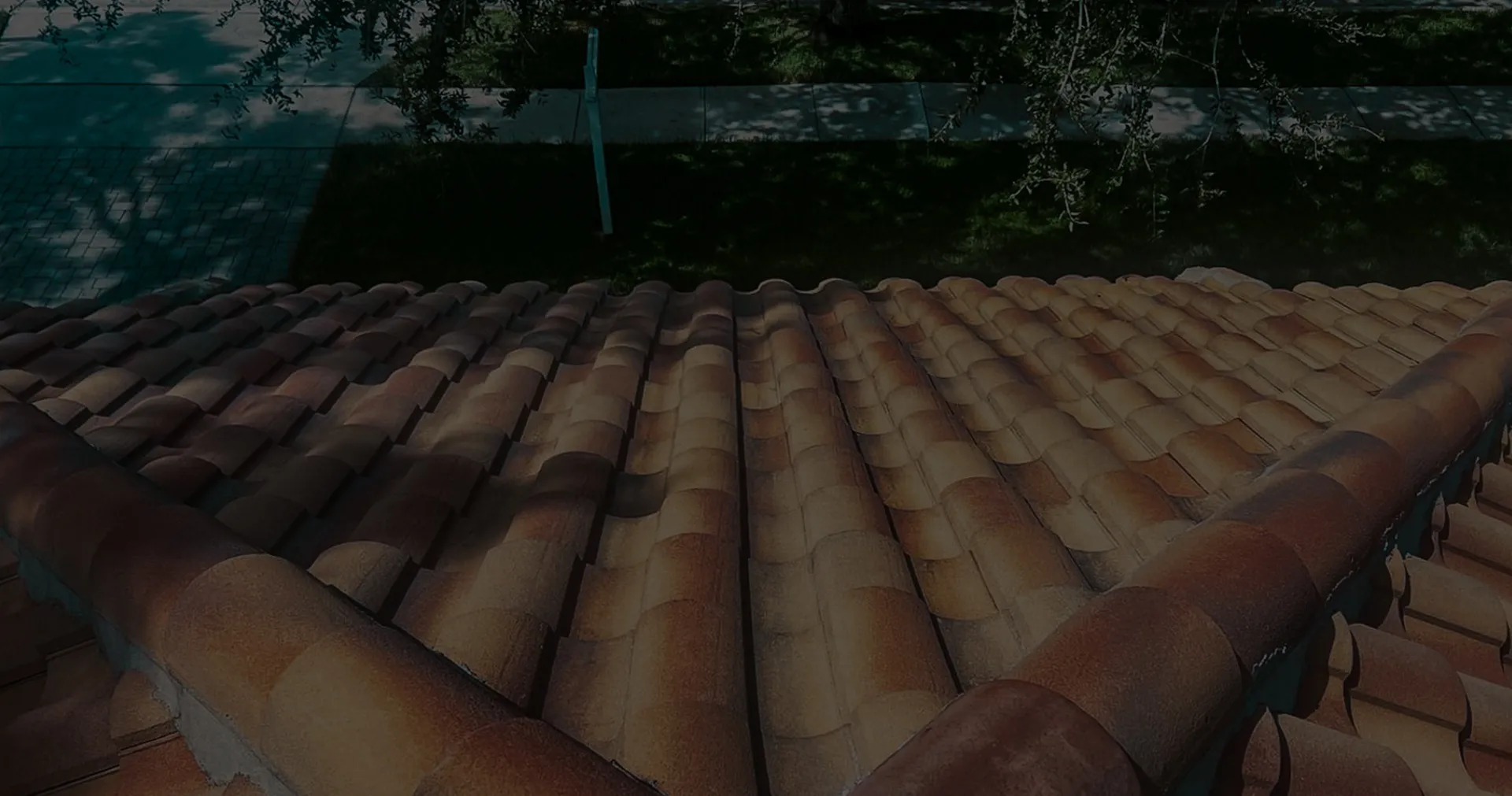 Close-up view of terracotta roof tiles on a house, showing the type of roof a tile roof repair service might work on.