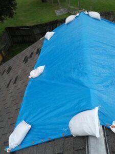 Temporary roof tarping