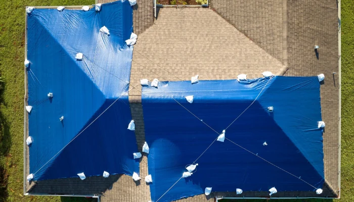 A blue tarp on the roof in the sun to represent the keyword blue tarp in the sun.