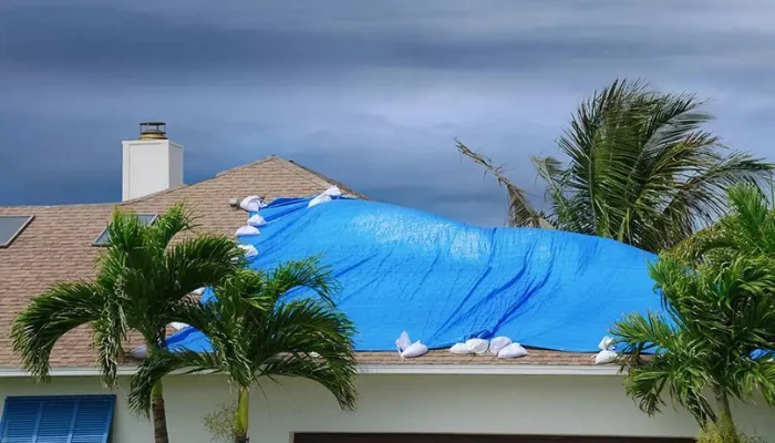 A roof with a blue tarp to represent the keyword blue tarp rain.