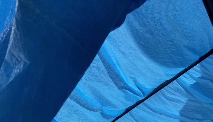 A blue tarp in the sun to represent the keyword blue tarp sun.