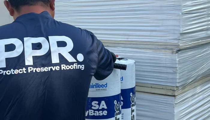 Conspicuous man wearing a Protect Preserve Roofing shirt.