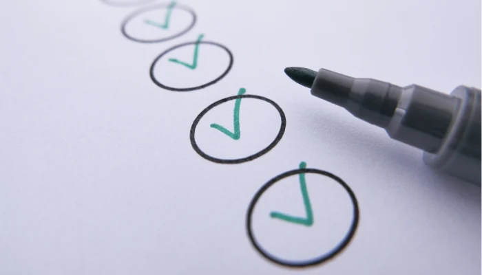 A paper with several circles marked as done and a pen next to it to represent the keyword step by step storm damage.