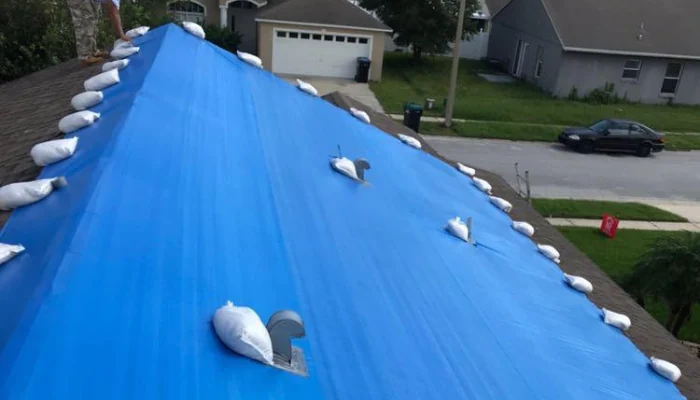 Blue tarp installed on a roof to represent the keyword blue tarp on the roof.