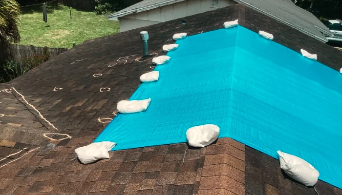 Blue tarpped roof to represent the keyword home insurance blue tarp.