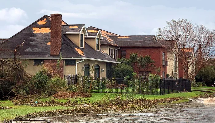 House with hurricane damaged roof to represent keyword storm damage roof.