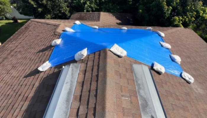 Blue tarp installed with sandbags to represent the keyword best way to use a tarp.