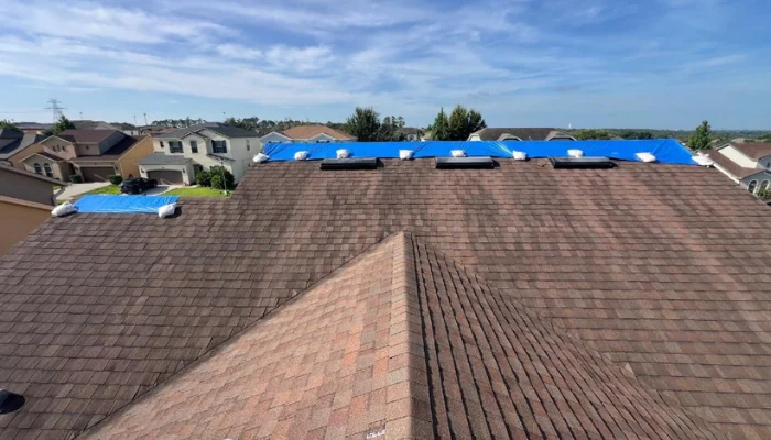 A roof with a blue tarp installed to represent the keyword blue tarp roof.