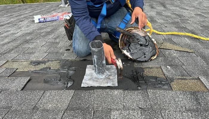 Man repairing a roof to represent the keyword roof repair.