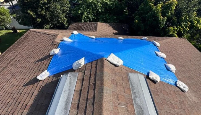 Blue tarp installed with sandbags to represent the keyword blue tarp installation.
