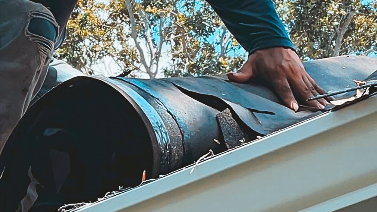 Man performing roof replacement to represent the keyword cost to replace roof.
