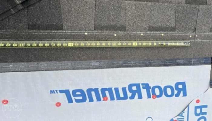 Measuring shingles to represent the keyword installing asphalt roof shingle.