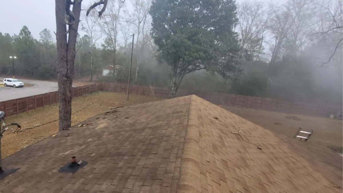 Shingle roof photographed in fog to represent the keyword does home warranty cover roof.