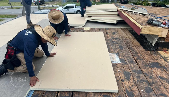 Team installing isobord on a roof to represent the keyword fixing flat roof problems.