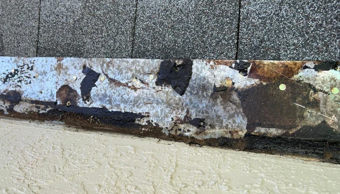 Metal roof damage (flashing) to represent the keyword metal roofing and storm damage.