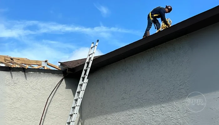 Man performing roof repair during the day to represent the keyword roof shingle repair cost.