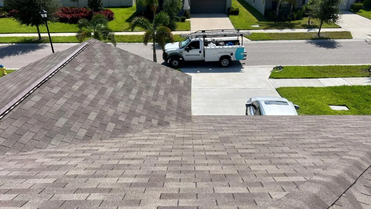 Roof photographed from above overlooking the street where a car is located to represent the keyword roof types.