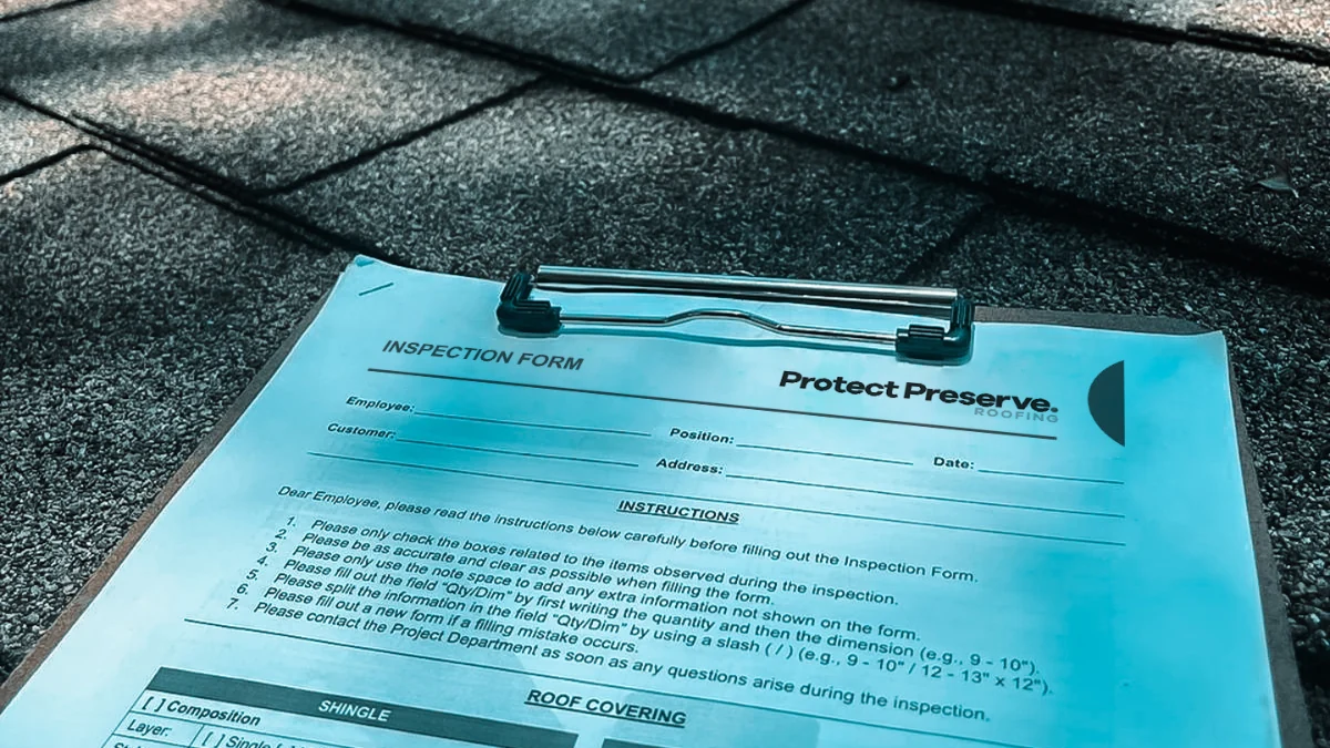 Clipboard with company paper on a roof to represent the keyword roof warranty.