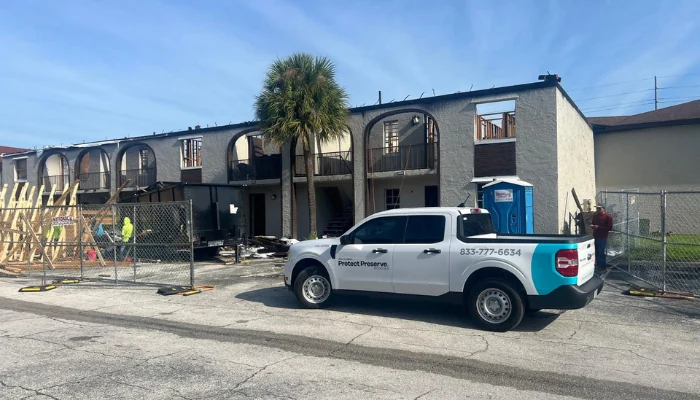 Car parked in front of a store to represent the keyword roofing contractor near me.