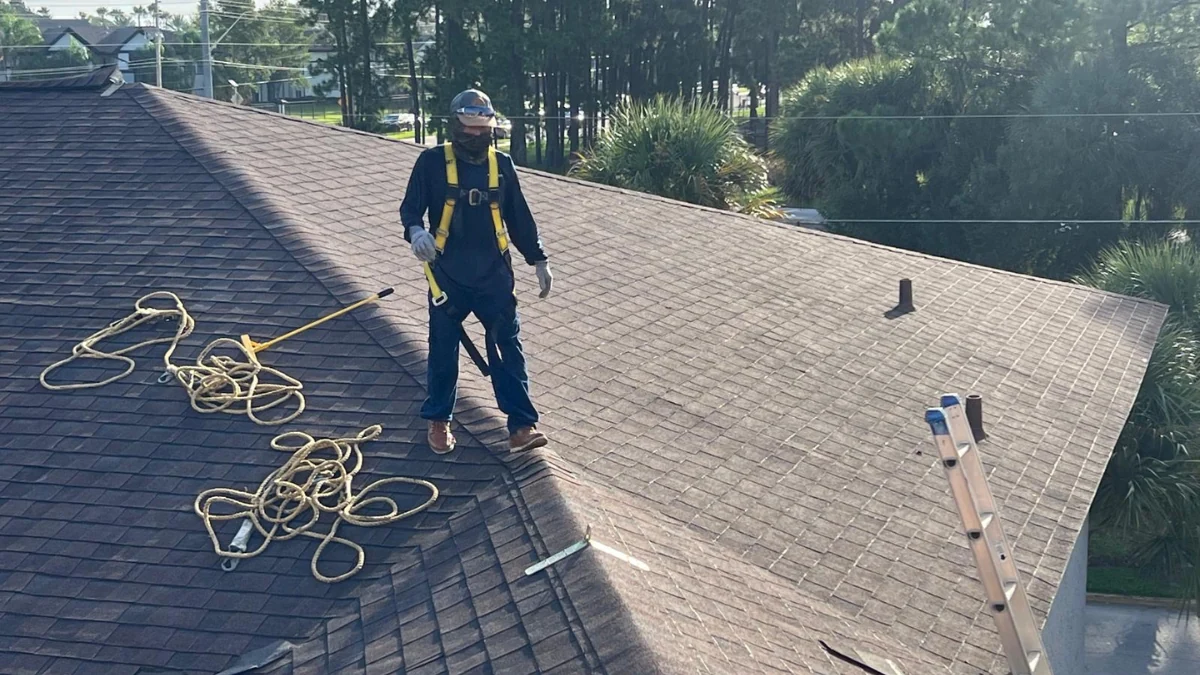 Man on top of roof to perform a repair to represent the keyword shingle roof repair.