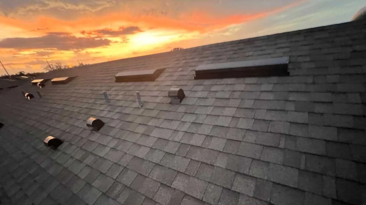 Sunset next to a rooftop to represent the keyword asphalt shingle roof repair near me.
