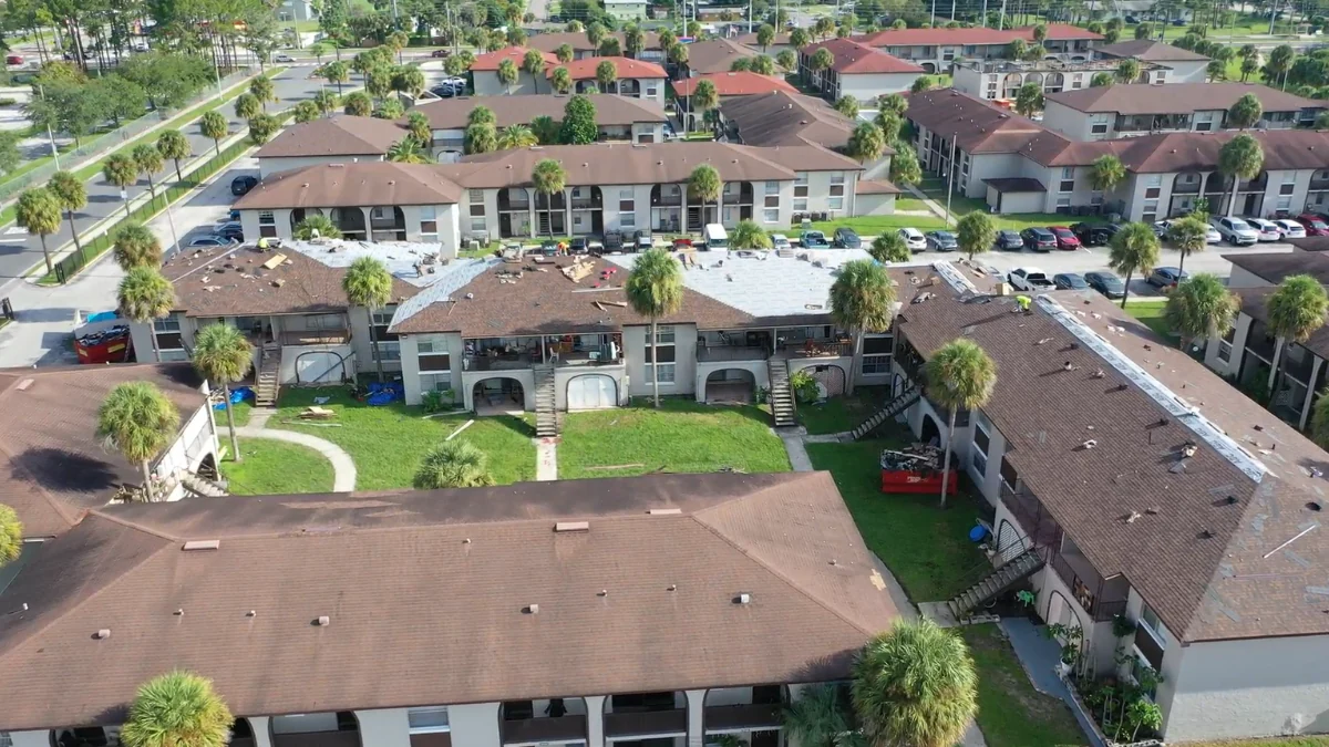 Neighborhood photographed from above with several roofs being replaced to represent the keyword best roofing company in orlando.