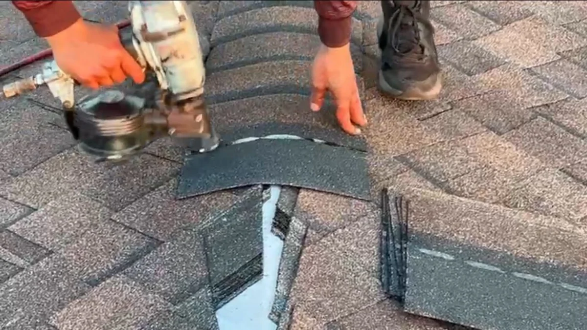 Man repairing a shingle roof to represent the keyword commercial roof replacement near me.