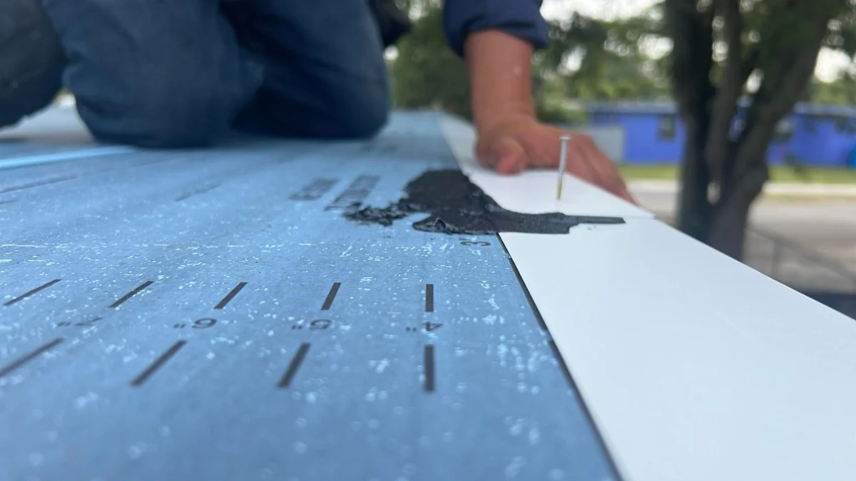 Man performing roof repair to represent keyword commercial roof replacement.