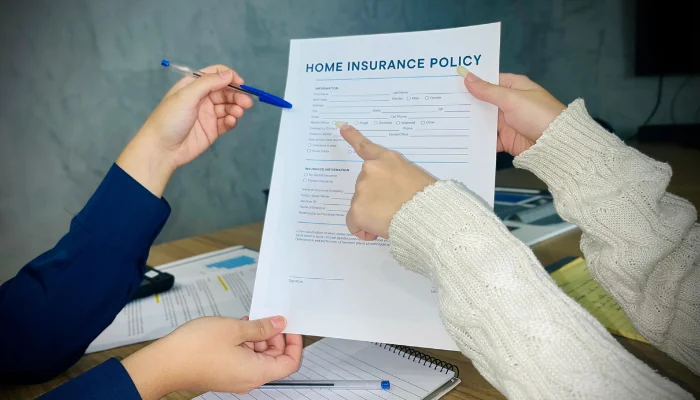 Woman hands holding insurance policy paper to represent keyword insurance policies.