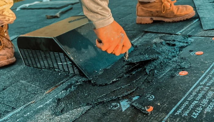 Man performing roof repair to represent keyword roof replacement.