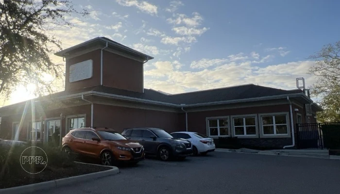 Vehicles parked next to a house during the day to represent the keyword commercial storm damage.