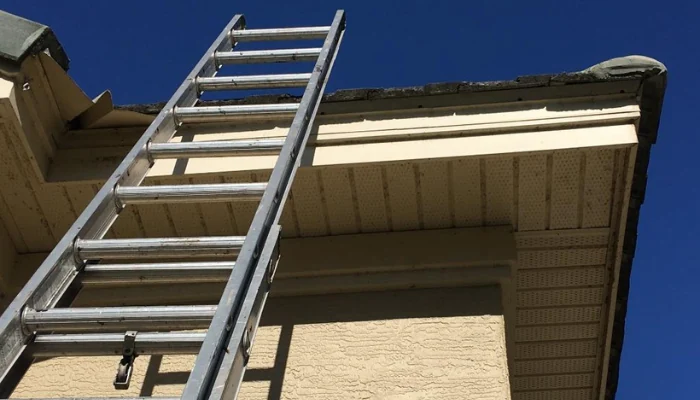Ladder placed next to the roof to represent the keyword storm damage shingle.