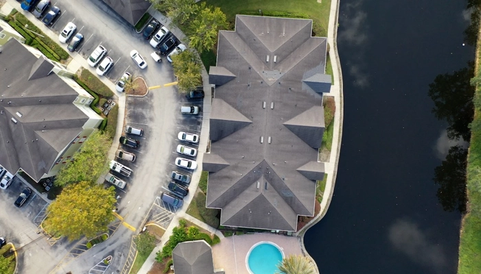 A roofing expert points to a damaged clay tile during a detailed inspection to help a homeowner file a roof insurance claim.