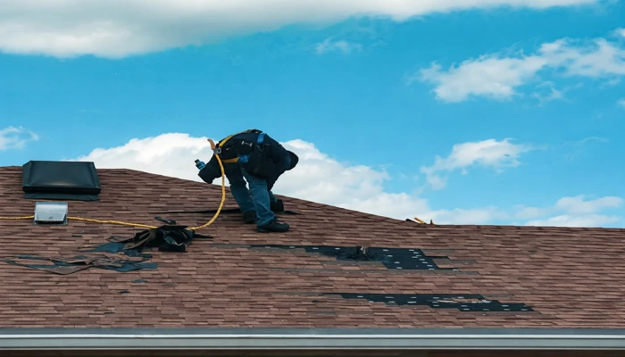Concrete tile roof vs asphalt shingles comparison showing asphalt shingle roof under repair due to wear, heat exposure, and weather damage.