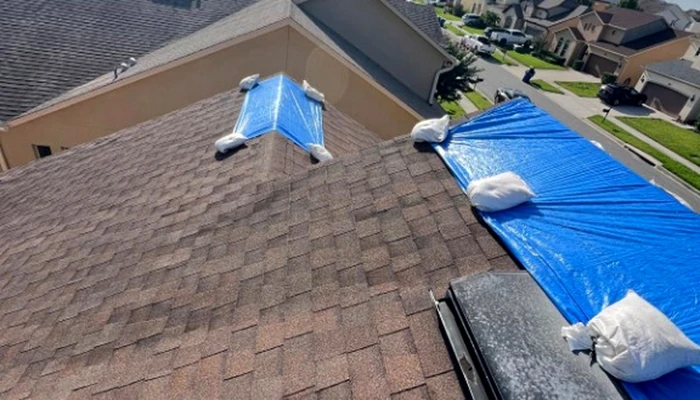 Blue tarp installed on a residential roof demonstrating how to protect your roof during a hurricane and prevent water intrusion.